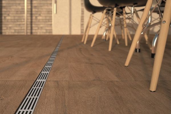 ACO Threshold Drain with a stainless steel grating installed on a patio